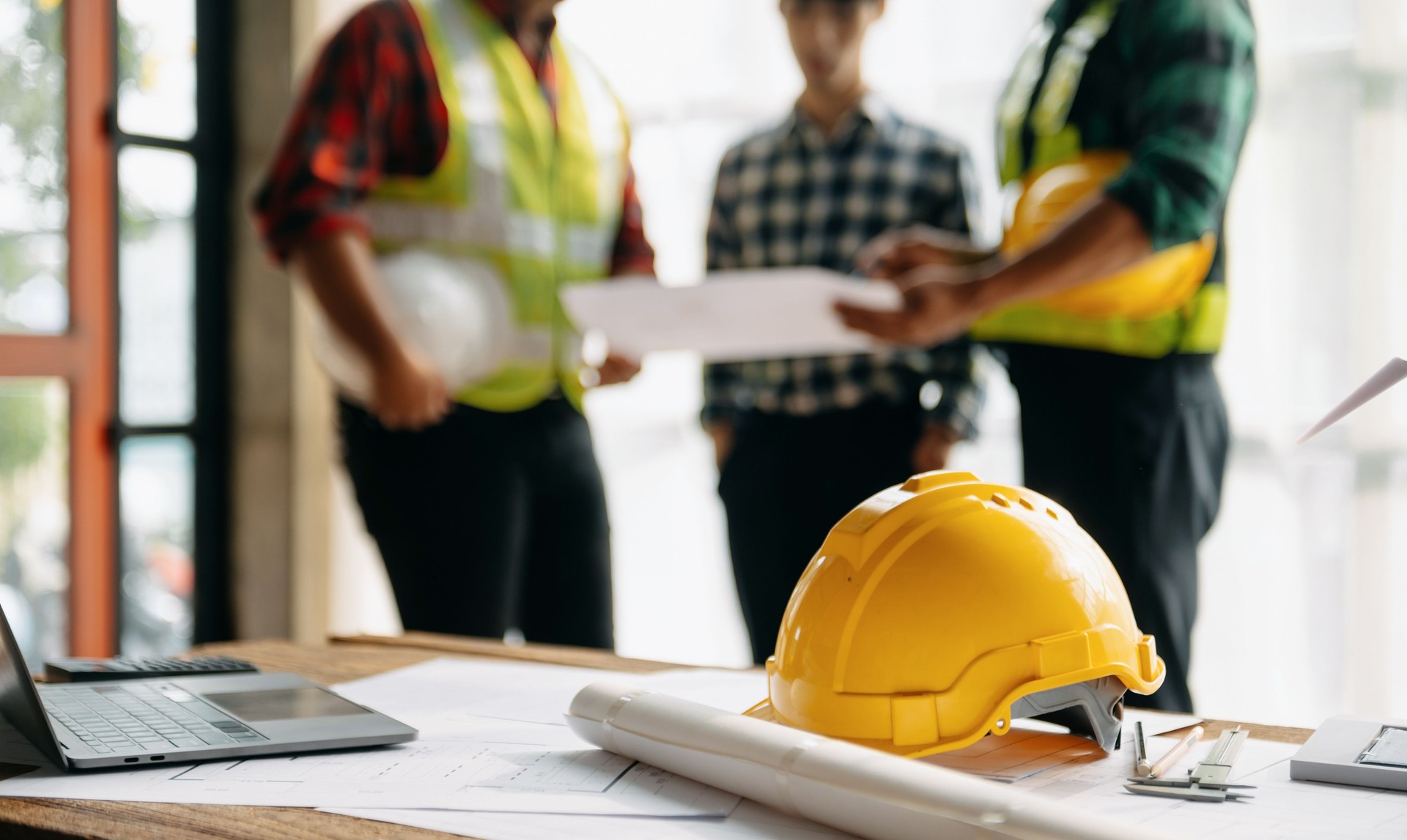 Engineer teams meeting working together wear worker helmets hardhat on construction site in modern city.Asian industry professional team